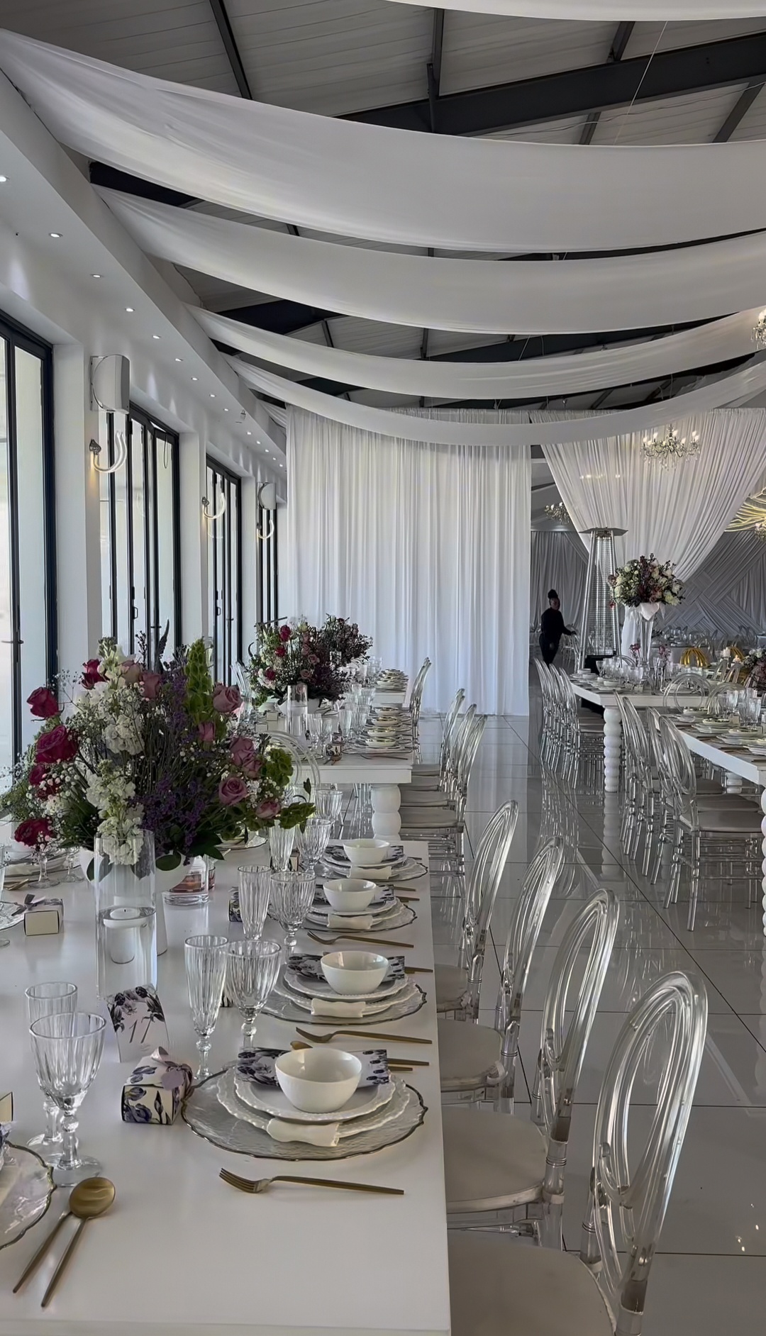 Long white tables with pink and purple florals