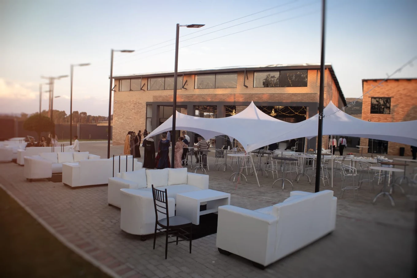 Guests unwinding in the Fast 5 outdoor lounge at sunset