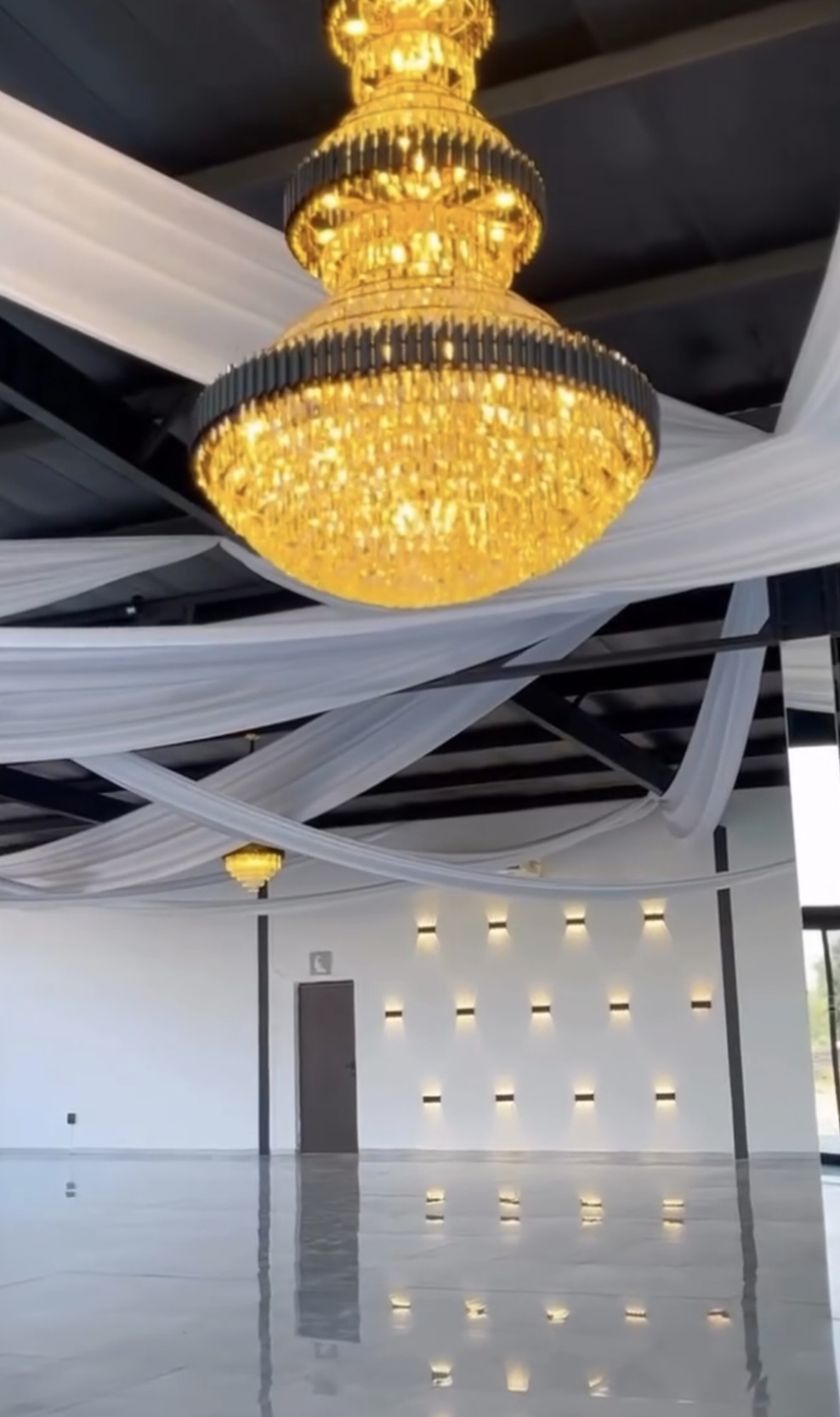 Gold chandelier above the polished floor