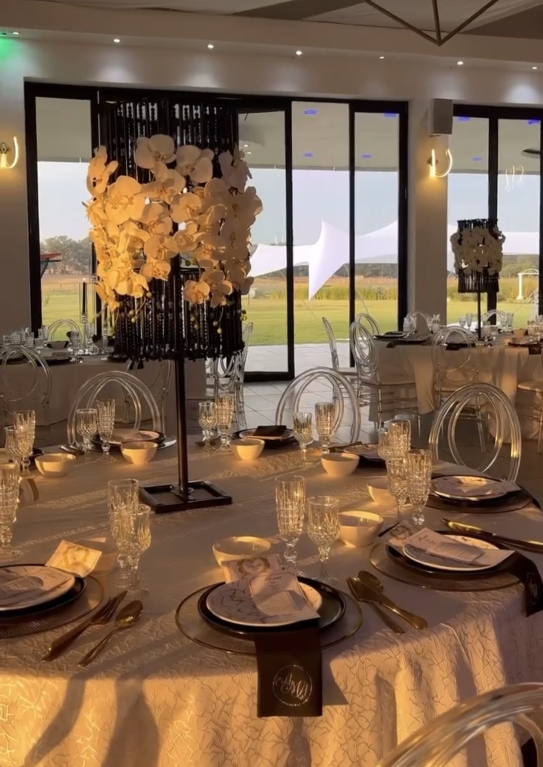 Sunset reception with orchid centrepieces over the lawns