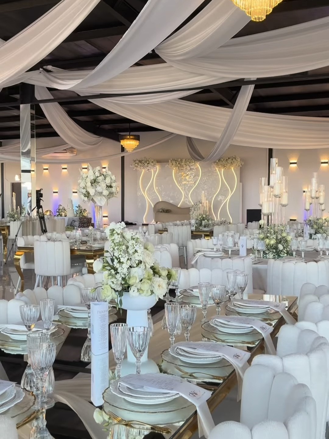 All-white banquet hall with gold tables