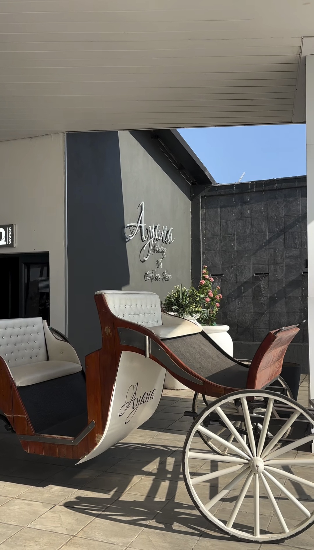 Ayana signage wall with the white carriage
