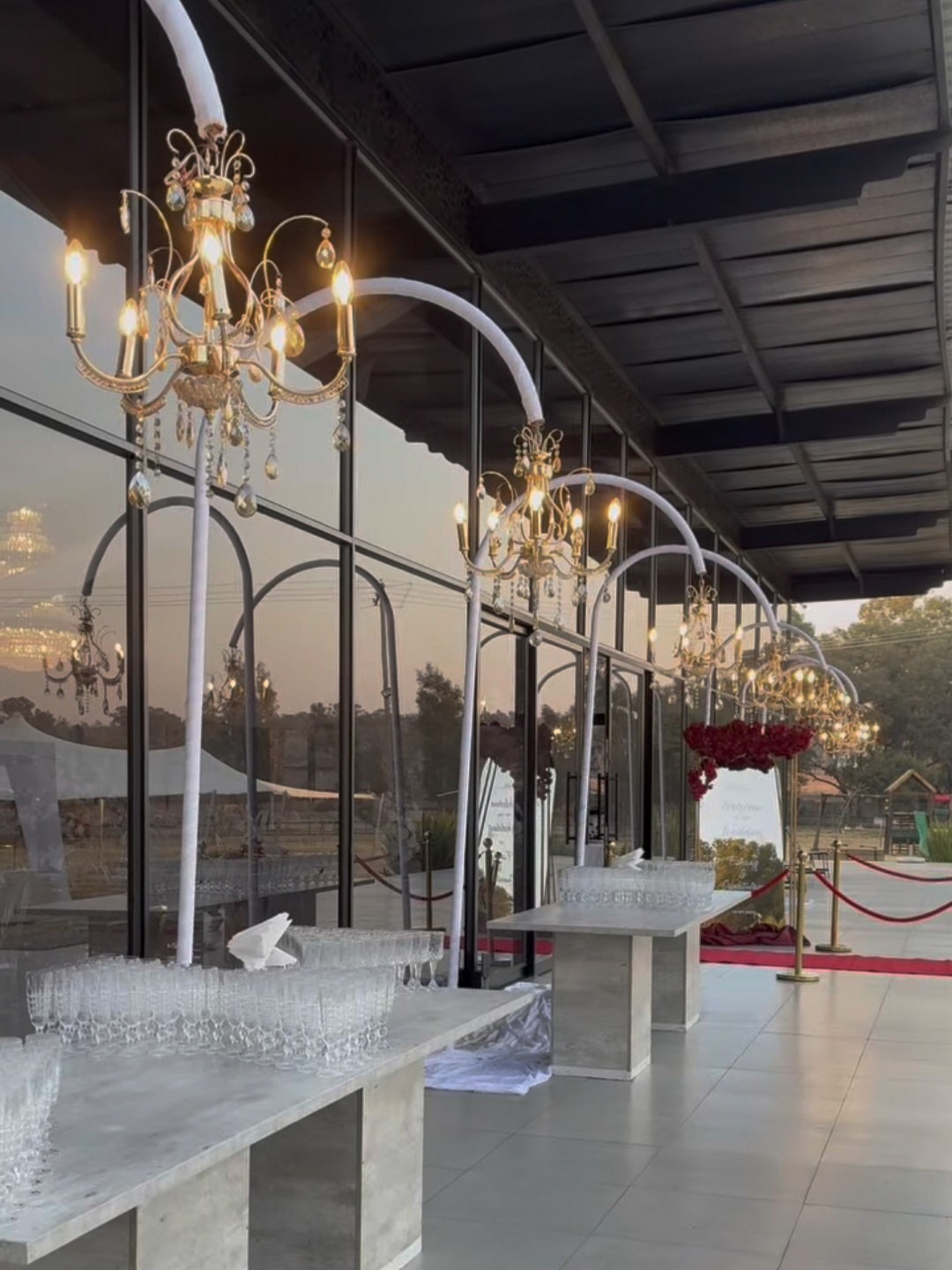 Chandelier arches along the glass facade