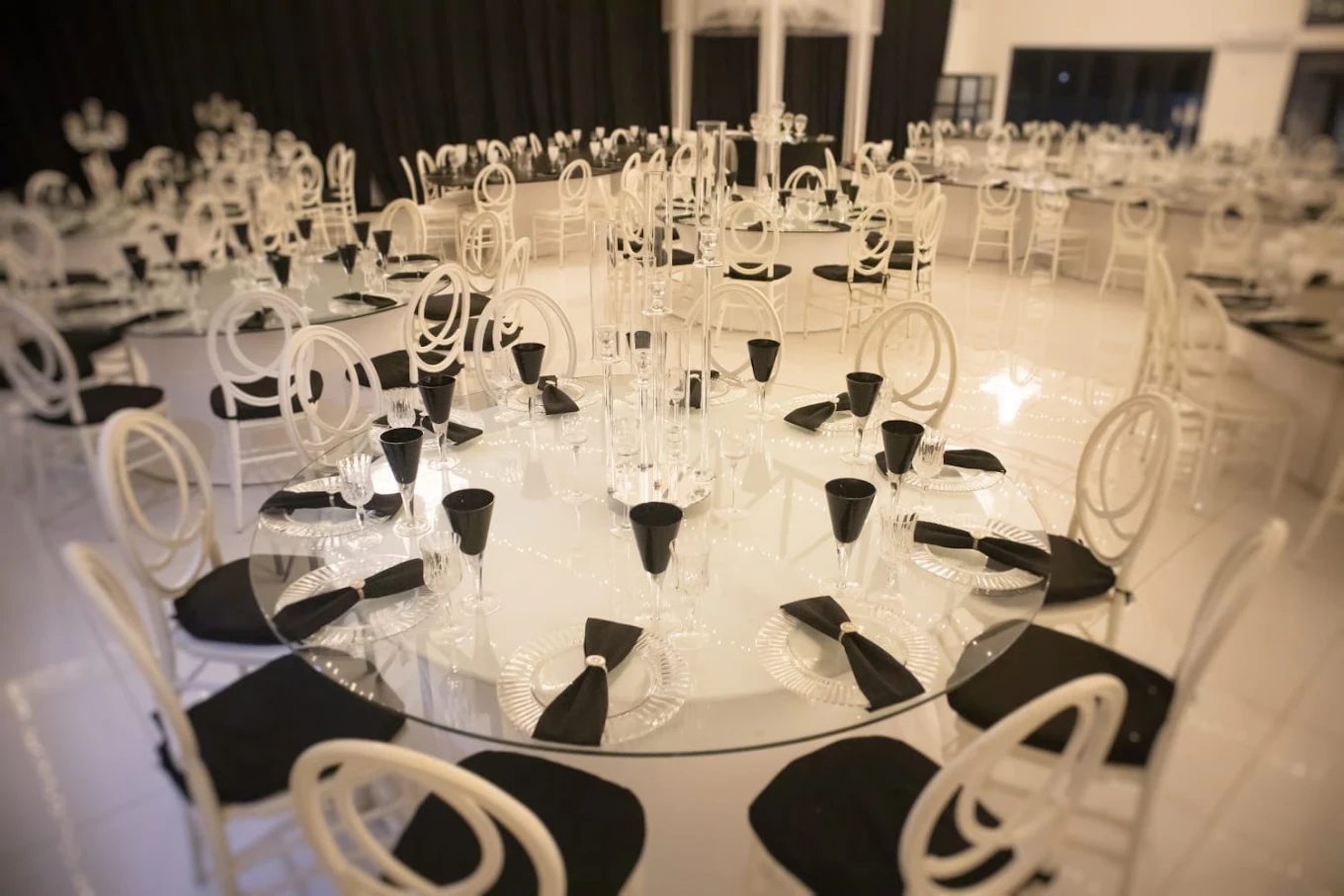 Round tables with candles and black napkins