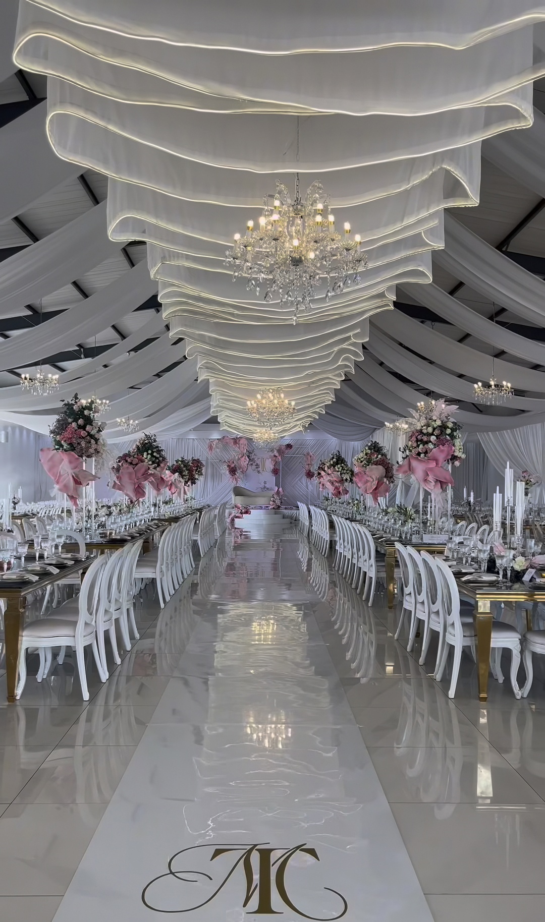 Blush and white draped hall with gold tables