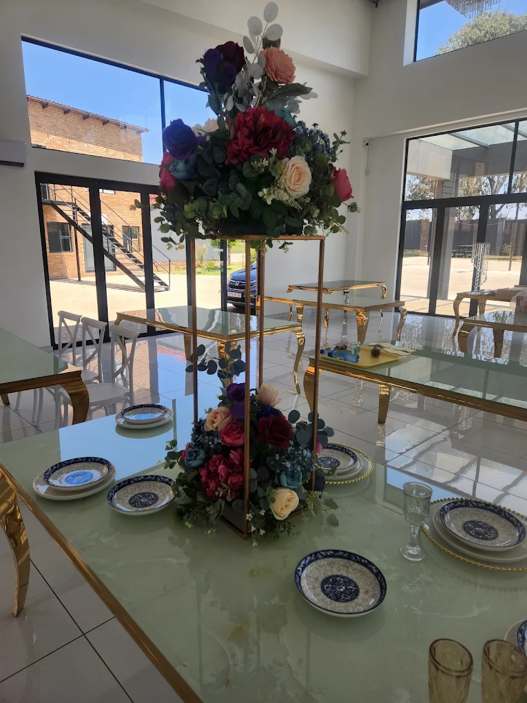 Glass-top dining tables with floral centrepieces
